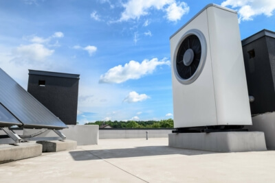 Wärmepumpe und Solarkollektor auf Dach - Beispiel für erneuerbare Energielösungen gemäß Bundesregierung Förderrichtlinien 2024 Kombination von Wärmepumpe und Solarkollektor auf einem Hausdach, repräsentativ für die Förderung erneuerbarer Energien in Deutschland ab 2024
