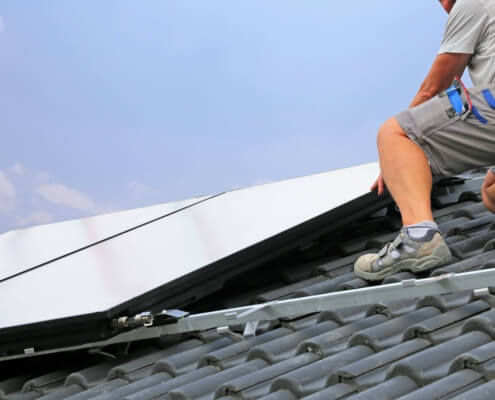 Montage von Photovoltaikanlage durch Handwerker auf Hausdach